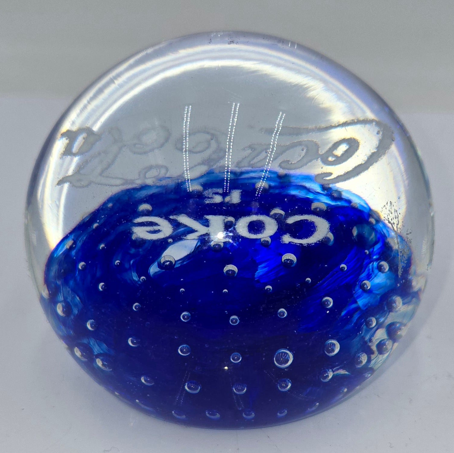 Coke is Coca-Cola glass advertising paperweight.  (100 Tickets Available)